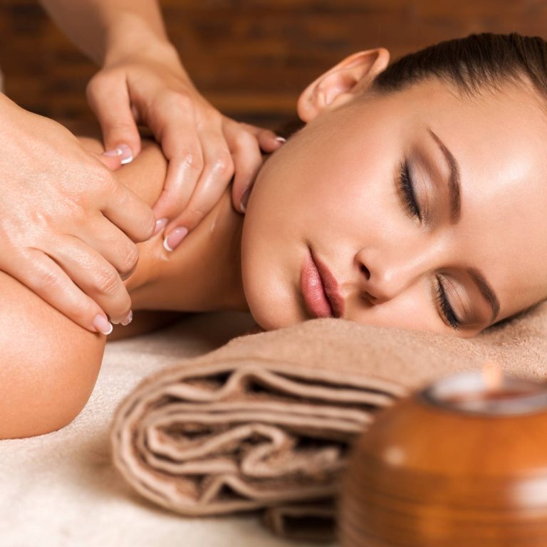 Closeup portrait of beautiful young woman with closed eyes relaxing in the spa salon. Beauty treatment concept.