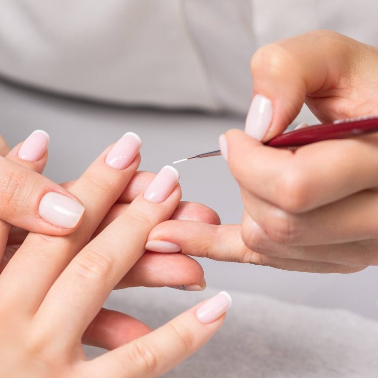 hand-of-young-woman-receiving-french-manicure-by-b-2026-03-26-04-03-09-utc